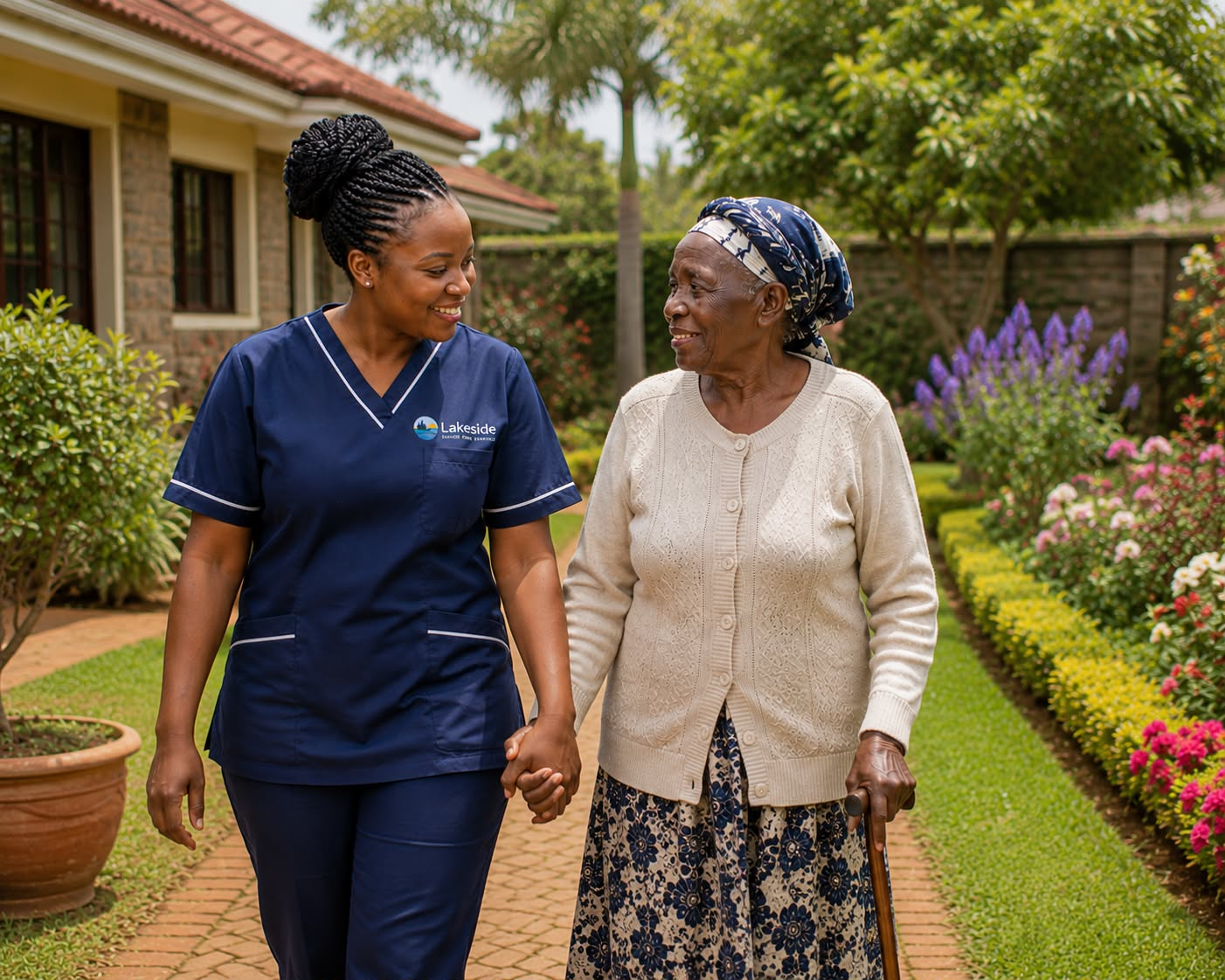 Caregiver walking with an elderly woman outdoors in Kenya